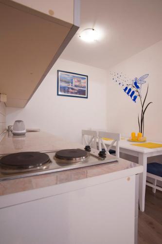 a kitchen with a counter top with a stove at Apartments Grand in Sveti Stefan