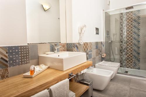 a bathroom with a sink and a toilet and a shower at B&B Villa Seta in Agrigento