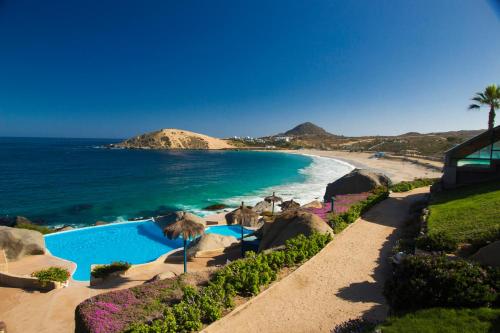 a beach with a swimming pool next to the ocean at Club Playa Blanca in Playa Blanca