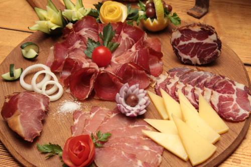 a plate of meats and cheese on a table at Hotel Prvan in Vrgorac
