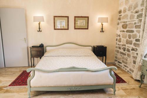 a bedroom with a bed with two night stands and two lamps at Palazzo Radomiri Heritage Boutique Hotel in Kotor