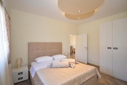 a bedroom with a large bed with white sheets at Pontus Luxury Apartments in Tivat