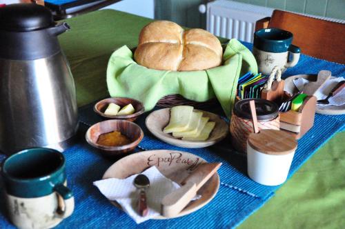 a table topped with a tray of bread and food at Hostal Epu Pewen in Curacautín