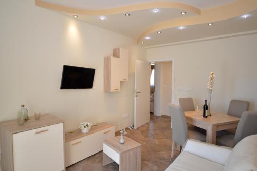 a living room with a couch and a dining room at Pontus Luxury Apartments in Tivat