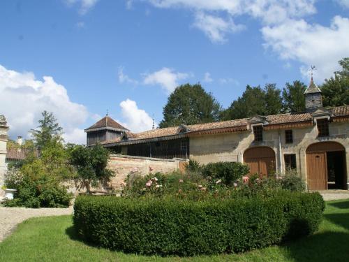 an old building with a bush in front of it at Superb villa with private heated pool in Revigny-sur-Ornain