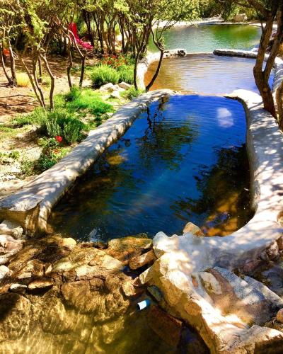 a pool of water with rocks in a river at Cabañas Luna de Cuarzo, Cochiguaz in Paihuano