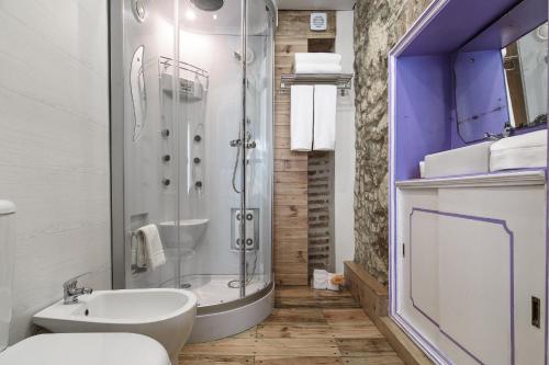 a bathroom with a shower and a toilet and a sink at My Bairro Alto Suites in Lisbon