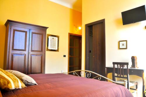 a bedroom with a bed and a door and a table at Villa Del Poeta in Sulmona
