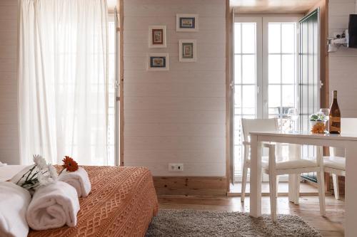 a bedroom with a bed with a desk and a table at My Bairro Alto Suites in Lisbon