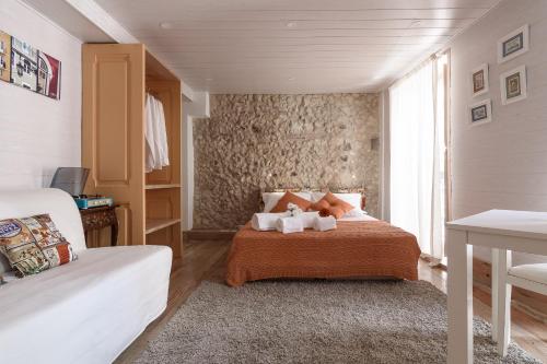 a bedroom with a bed with two stuffed animals on it at My Bairro Alto Suites in Lisbon