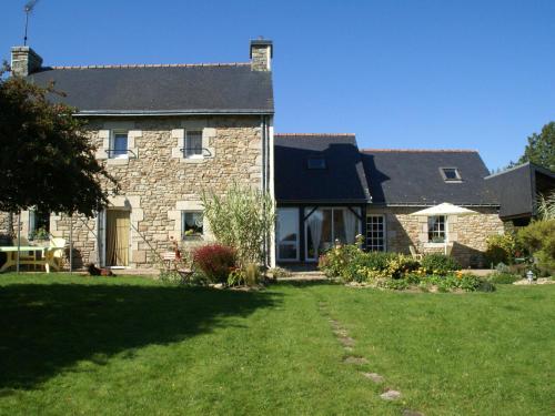 a large stone house with a lawn in front of it at Relaxing g te with terrace near Pont Aven in Mellac