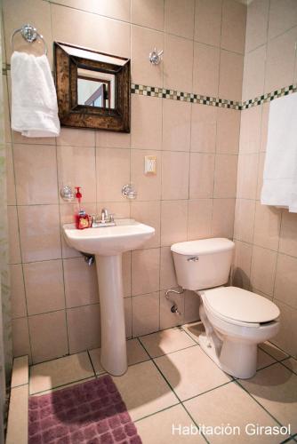 a bathroom with a toilet and a sink at Flor de Cera in Tepoztlán