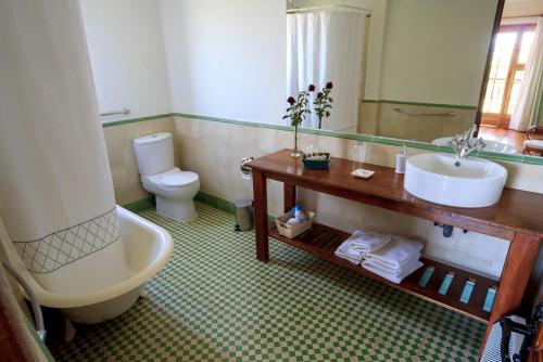 a bathroom with a toilet, sink and tub at Hotel Terraviña in Santa Cruz