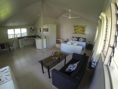 a living room with a couch and a table at Savaii Lagoon Resort in Fagamalo