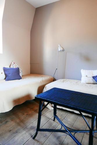 En eller flere senge i et værelse på Gîte Le Puits Salé