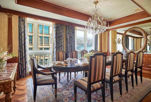 a dining room with a table and chairs and a chandelier at Four Seasons Cairo At The First Residence in Cairo