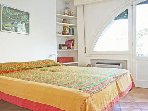una camera da letto con un grande letto con una grande finestra di Charming Holiday Home at Massa Lubrense Naples with Balcony a Massa Lubrense