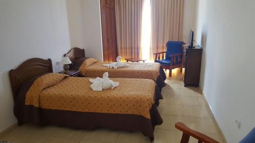 a hotel room with two beds with towels on them at Apartamentos Los Saltos in La Restinga