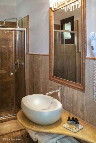 a bathroom with a white sink and a shower at Augustus Resort in Santa Cesarea Terme