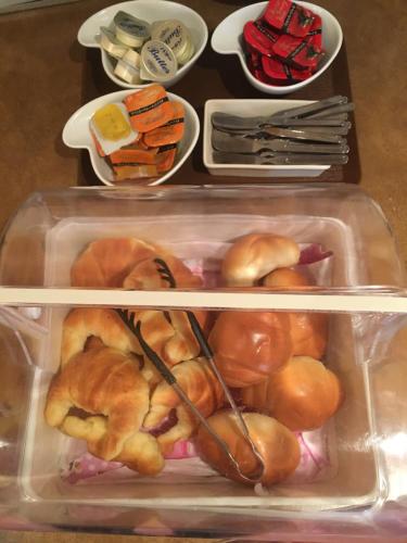 a refrigerator with two shelves full of food at Hotel Crown Hills Yamagata in Yamagata