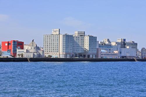 a view of a city with a large body of water at Ocean Suites Jeju Hotel in Jeju