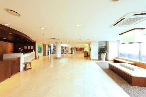a lobby of a building with a reception desk at Ocean Suites Jeju Hotel in Jeju