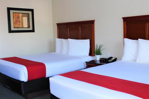 a hotel room with two beds and a telephone at Rodeway Inn South San Francisco Airport in South San Francisco