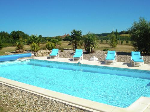 a swimming pool with blue lounge chairs next to it at Detached villa in a beautiful area in La Croix-Blanche