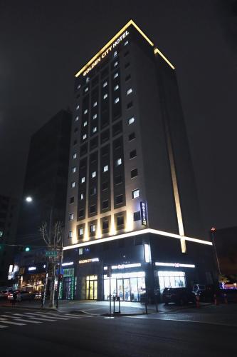ソウルにあるゴールデン シティ ホテル 東大門の夜に看板が掲げられた高層ビル