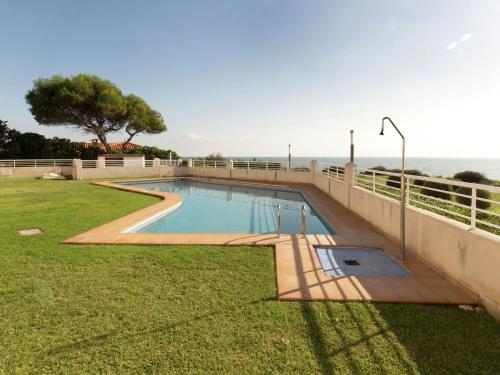a swimming pool with the ocean in the background at Quaint Apartment close to the Seabeach in Vinarós