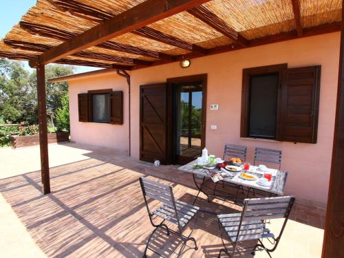 a patio with a table and chairs on a deck at Farmhouse in Montalto near Sandy Beach in Montalto di Castro