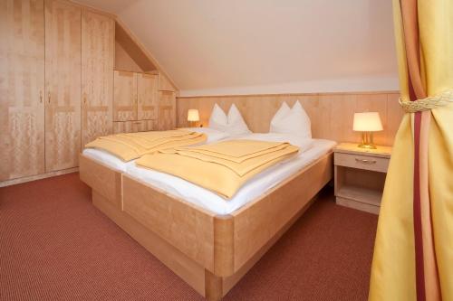 ein Schlafzimmer mit einem großen Bett in einem Zimmer in der Unterkunft Pension Seevilla Annelies in Maria Wörth