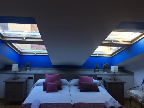 1 dormitorio con 2 camas con almohadas moradas en Duplex Torico Amantes, en Teruel
