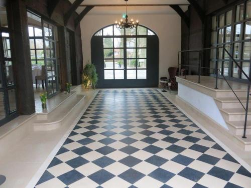 a hallway with a checkered floor in a building at Romantik Hotel Hof zur Linde in Münster