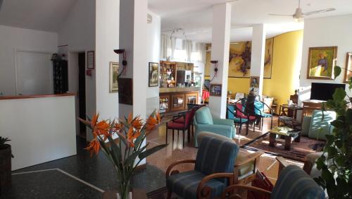 a living room with a bunch of chairs at Hotel Colibrì in Finale Ligure