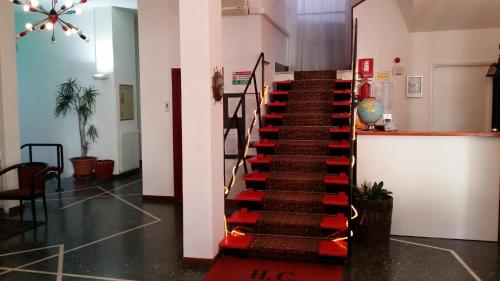 a staircase in a building with a red and black railing at Hotel Colibrì in Finale Ligure