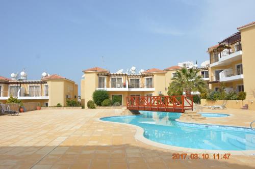 a villa with a swimming pool and a bridge at Luxury Apartment in Paphos