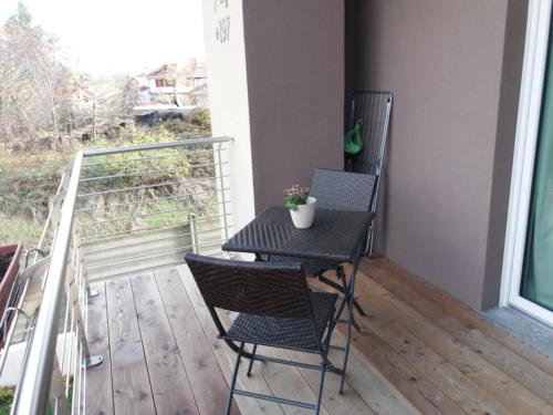 a small table and two chairs on a balcony at La Casa Di Kiki in Cuneo