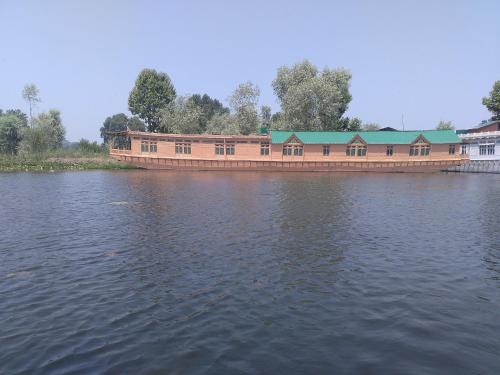 a large building on the side of a body of water at Kings Houseboats in Srinagar