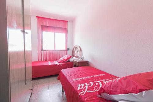 サロウにあるCapellans IBERPLAYAのベッド2台と窓が備わる小さな客室です。
