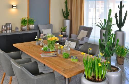 a dining room with a wooden table and chairs at Hotel Residenz Oberhausen in Oberhausen