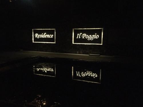 a group of signs on a wall in the dark at Residence Il Poggio in Dorio