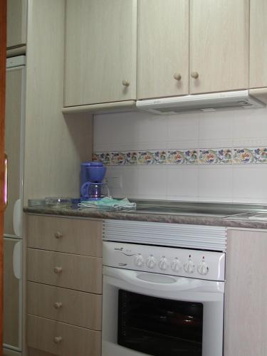 a kitchen with a white stove top oven at Urbanizacion Naturista La Menara in Vera