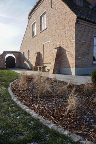 a brick building with a bench in front of it at Boutique Hotel De Brakelhoen in Brakel