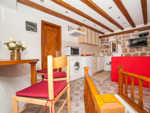 a kitchen and living room with a table and chairs at Apartment Alexandra in Kotor
