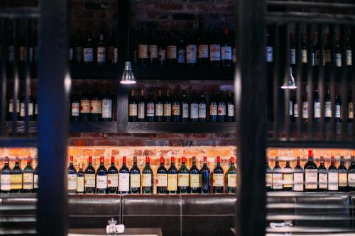 a bunch of bottles of wine on a shelf at mour hotel in Mansfield