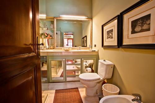 a bathroom with a toilet and a sink and a mirror at Luxury Villa Golf Tenerife in Tacoronte
