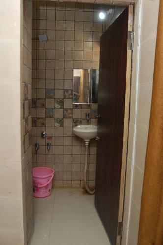 a small bathroom with a sink and a toilet at Hotel Milan in Dwarka