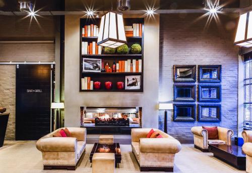 a living room with two couches and a fireplace at mour hotel in Mansfield