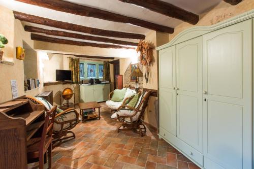 a living room with a piano and rocking chairs at Hotel Rural El Pilaret in Azanúy